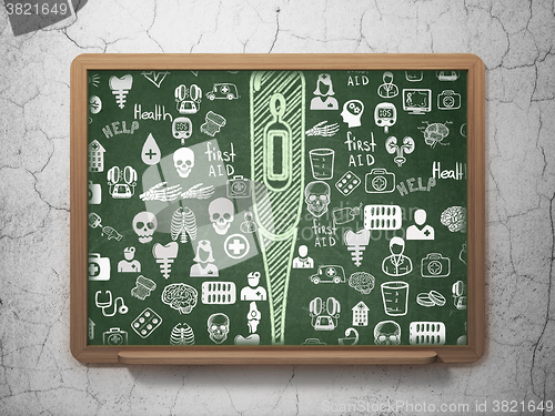 Image of Health concept: Thermometer on School Board background