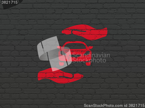 Image of Insurance concept: Car And Palm on wall background