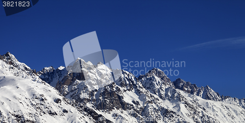 Image of Panoramic view on snowy rocks and blue clear sky at nice sun day