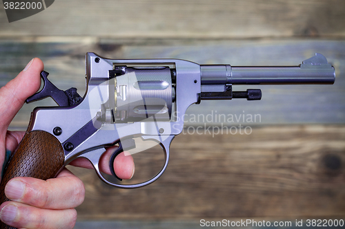 Image of human hand with revolver