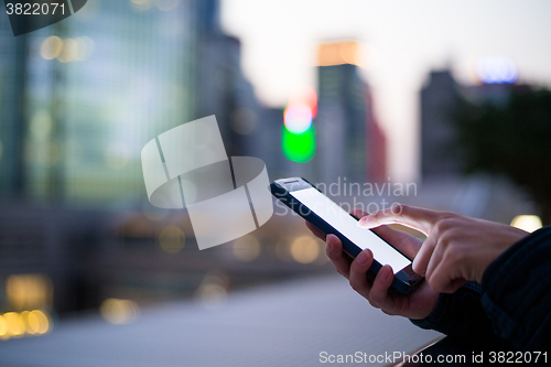 Image of Woman using her Mobile Phone in the street