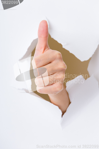 Image of Human hand gesturing thumbs up