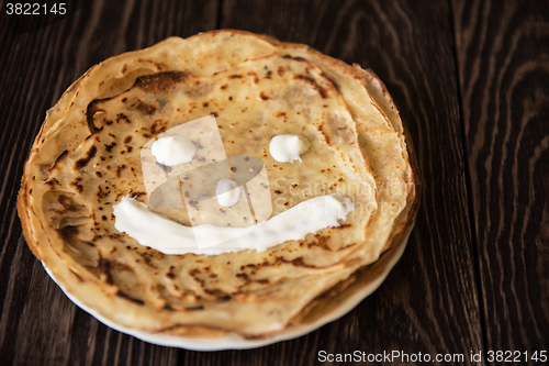 Image of Fried tasty smiling pancakes 