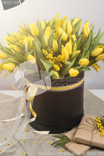 Image of Bright spring bouquet of tulips and mimosa flowers