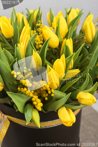 Image of Bright spring bouquet of tulips and mimosa flowers