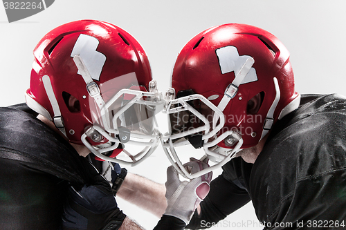 Image of The two american football players fighting on white background