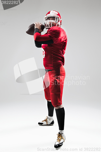 Image of American football player posing with ball on white background