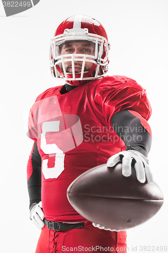 Image of American football player posing with ball on white background