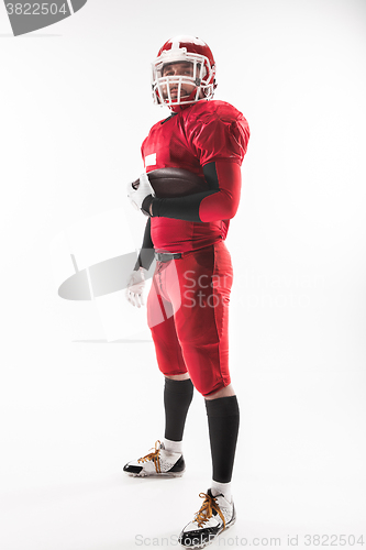 Image of American football player posing with ball on white background