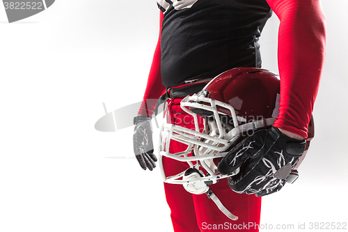 Image of American football player posing with helmet on white background