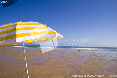 Image of yellow umbrella at the beach