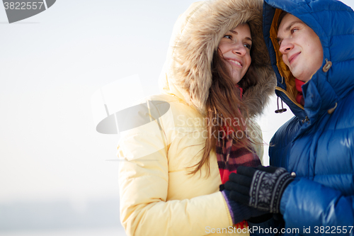 Image of beautiful couple embracing in winter