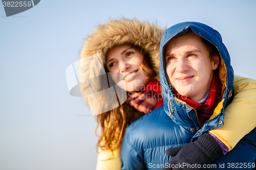 Image of beautiful couple embracing in winter