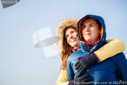 Image of beautiful couple embracing in winter