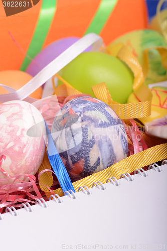 Image of Arrangement of Gift Boxes in Wrapping Paper with Checkered Ribbons and Decorated Easter Eggs isolated on white background