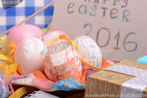 Image of hand made eggs at a gift box, happy easter invitation card