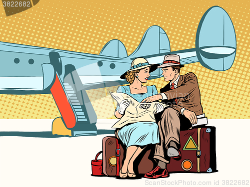 Image of Tourists couple looking at the map, after landing
