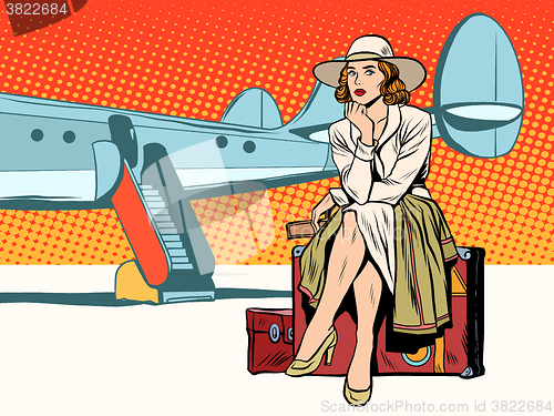 Image of Tourist girl sitting on a suitcase, travelling by plane