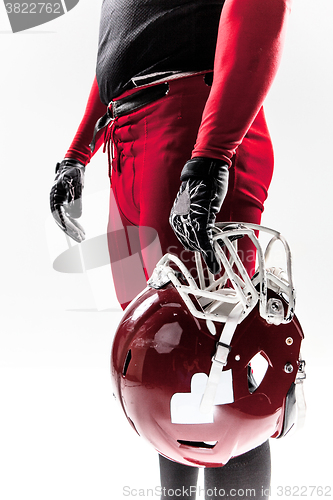 Image of American football player posing with helmet on white background