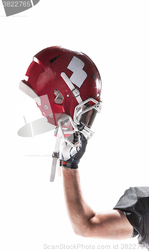 Image of The hand of american football player with helmet on white background