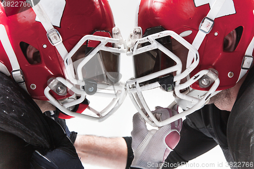 Image of The two american football players fighting on white background