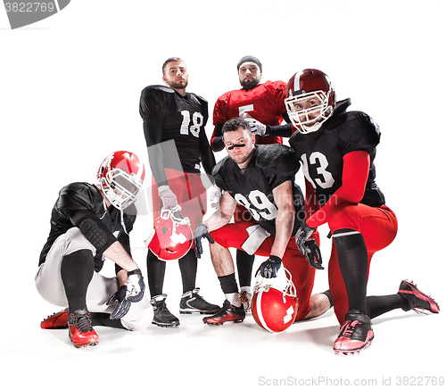 Image of The five american football players posing with ball on white background