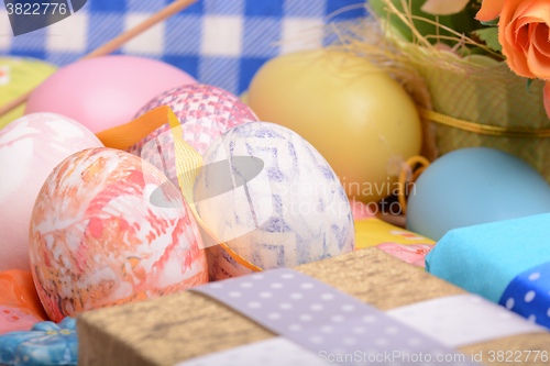Image of Arrangement of Gift Boxes in Wrapping Paper with Checkered Ribbons and Decorated Easter Eggs isolated on white background
