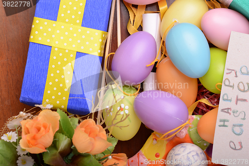 Image of Arrangement of Gift Boxes in Wrapping Paper with Checkered Ribbons and Decorated Easter Eggs isolated on white background