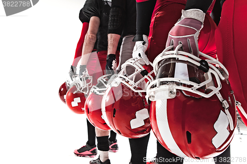 Image of The hands of american football players with helmets on white background