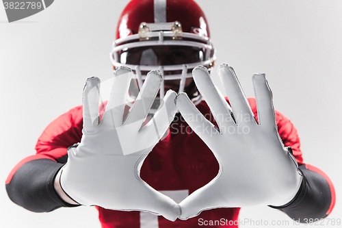 Image of The hands of american football player on white 