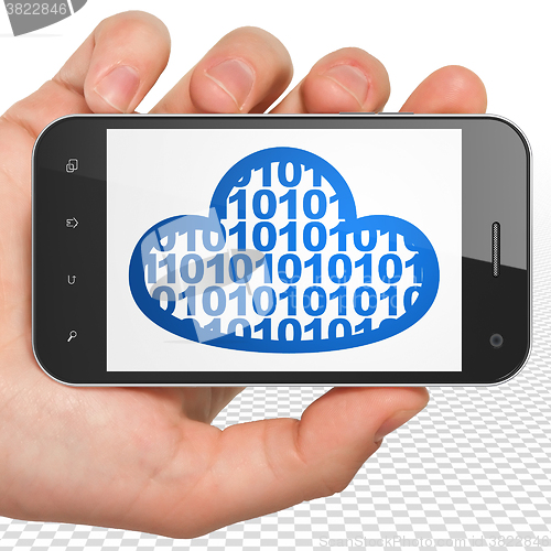 Image of Cloud networking concept: Hand Holding Smartphone with Cloud With Code on display