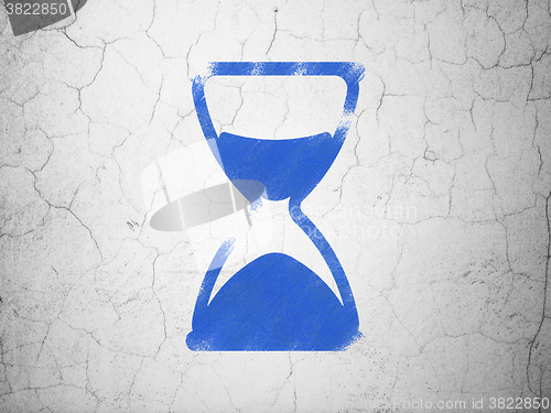 Image of Timeline concept: Hourglass on wall background