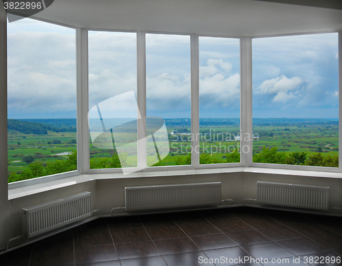 Image of modern window of veranda with thundercloud landscape 