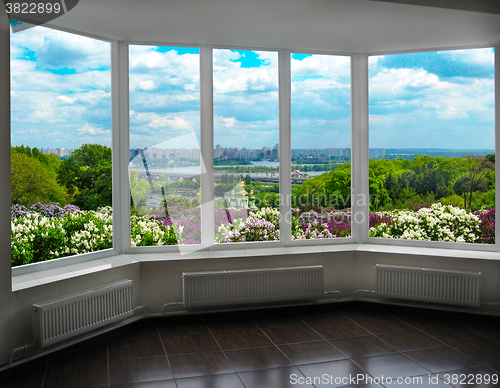 Image of plastic window with view of Kyiv in spring