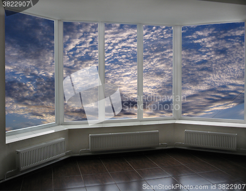 Image of plastic windows overlooking the sunset with clouds