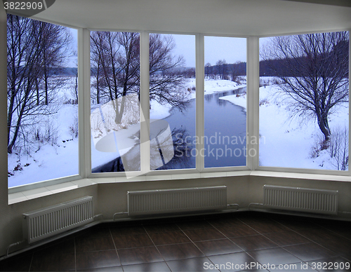 Image of windows of room overlooking the winter river