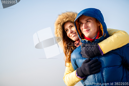 Image of beautiful couple embracing in winter