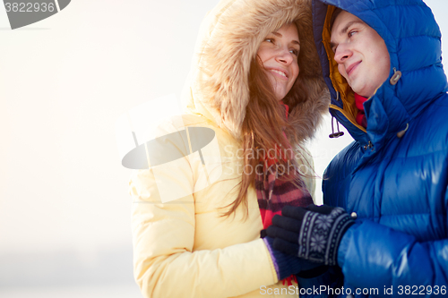 Image of beautiful couple embracing in winter