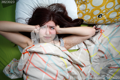 Image of Tired woman sleeping on a bed at home