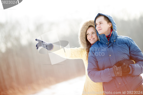 Image of Young couple walking in a park. Winter season.