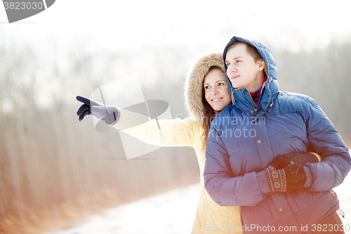 Image of Young couple walking in a park. Winter season.