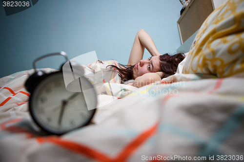 Image of Woman with insomnia touching her head