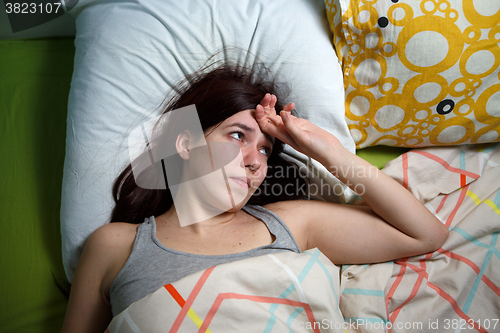 Image of Tired woman sleeping on a bed at home