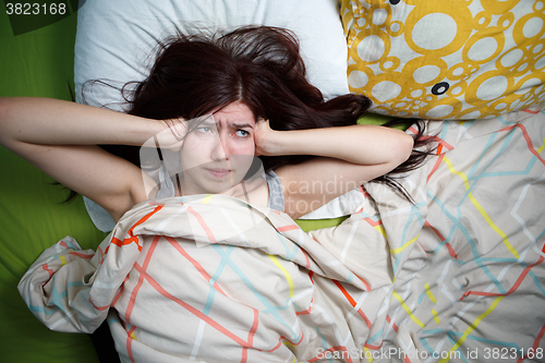 Image of Tired woman sleeping on a bed at home