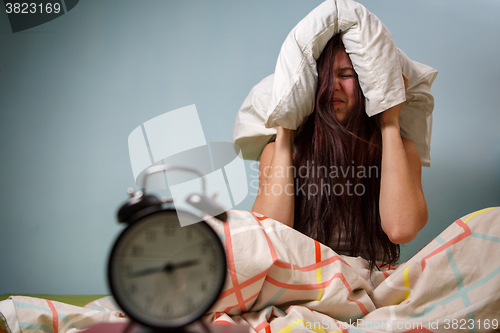 Image of Woman with a pillow over head.