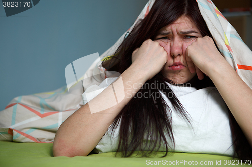 Image of Woman with blanket under her head