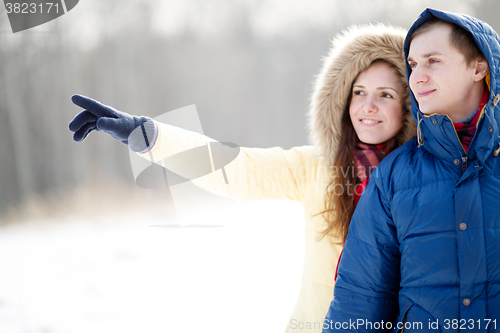Image of Young couple walking in a park. Winter season.