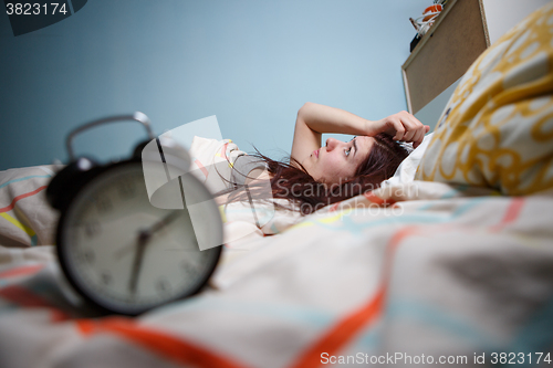 Image of Woman with insomnia touching her head