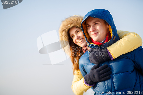 Image of beautiful couple embracing in winter