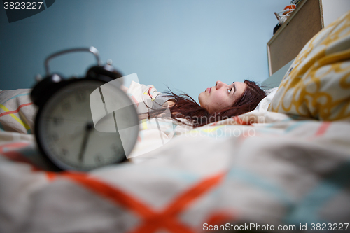 Image of Woman with insomnia touching her head